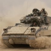 041030-F-2034C-040<br /> An M2A2 Bradley Fighting Vehicle kicks up plumes of dust as it leaves Forward Operating Base MacKenzie in Iraq for a mission on Oct. 30, 2004. The Bradley is assigned to Alpha Troop, 1st Battalion, 4th Cavalry Regiment, 1st Infantry Division. DoD photo by Staff Sgt. Shane A. Cuomo, U.S. Air Force. (Released)